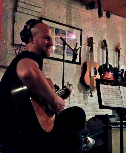 Chris, professional guitar teacher, tracking acoustic guitar in a Brooklyn music studio.
